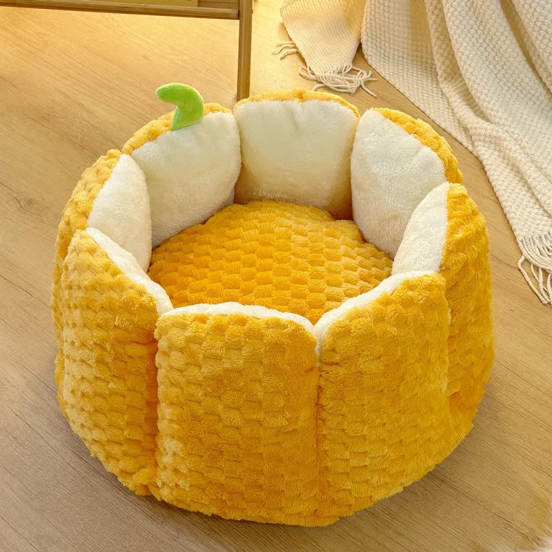 Orange pumpkin-shaped pet bed for cats and small dogs with raised sides and cotton filling