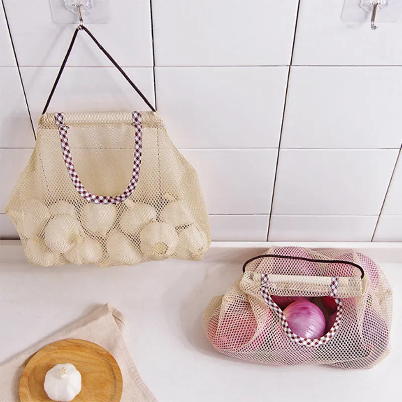 Beige plaid polyester mesh storage bag with cotton rope hanging loop on a white wall