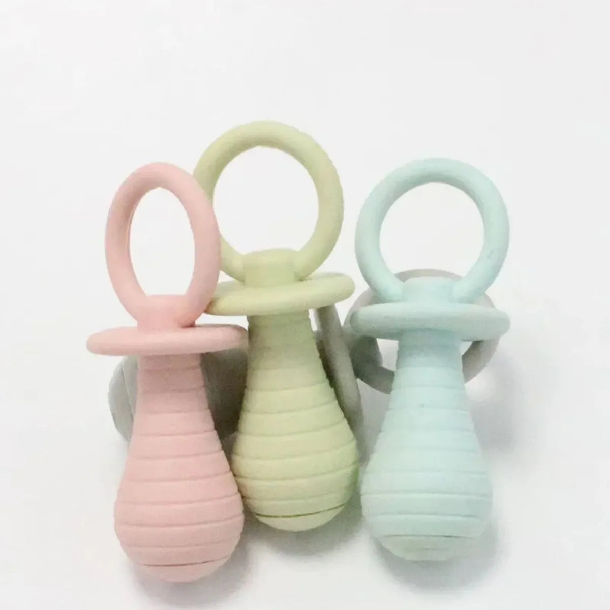 TPR pet pacifier squeaker toys for puppies and kittens in blue, grey, green, and pink colours