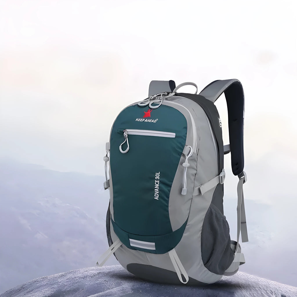 30-litre dark green waterproof mountaineering backpack with airpillow straps on a rocky outdoor trail
