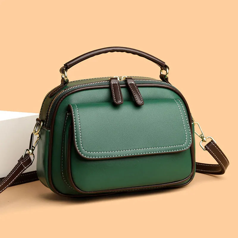 Women's black PU cross-body shoulder bag showing square shape and double connector straps