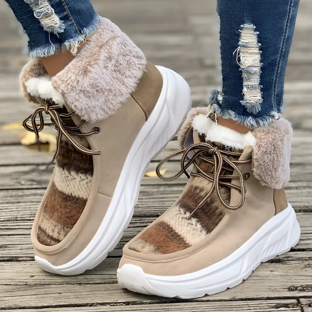 Women's beige lace-up snow boots with suede upper, thick rubber sole, and fuzzy lining.
