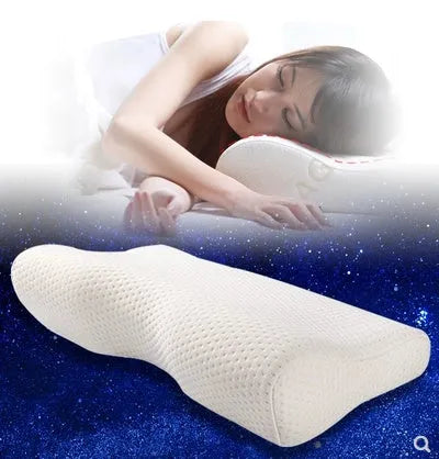 Blue butterfly-shaped memory foam cervical neck pillow on a bed