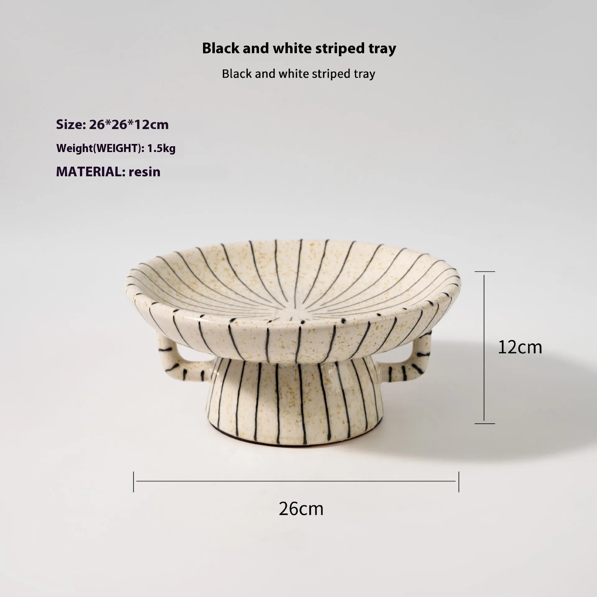 Black and white striped synthetic resin fruit plate on a table.