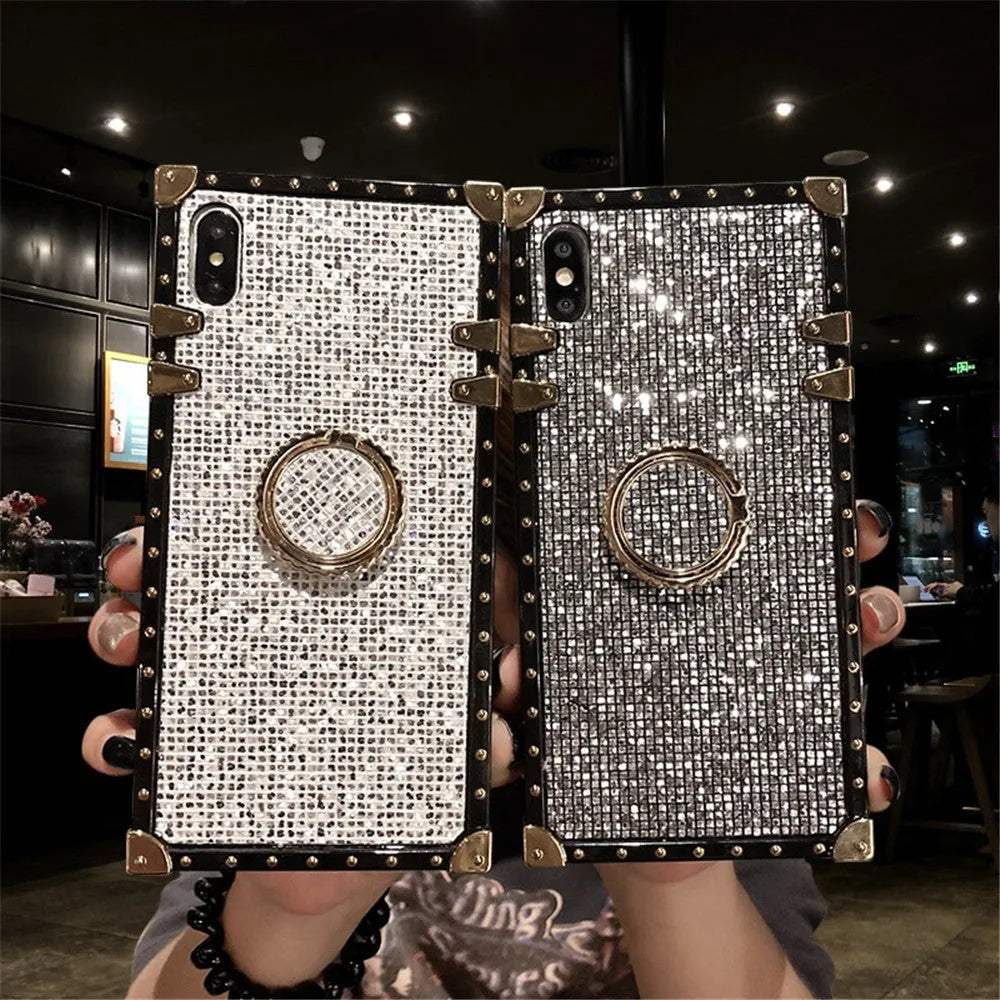 Square clear TPU mobile phone case with a silver flash diamond bracket on a smartphone.