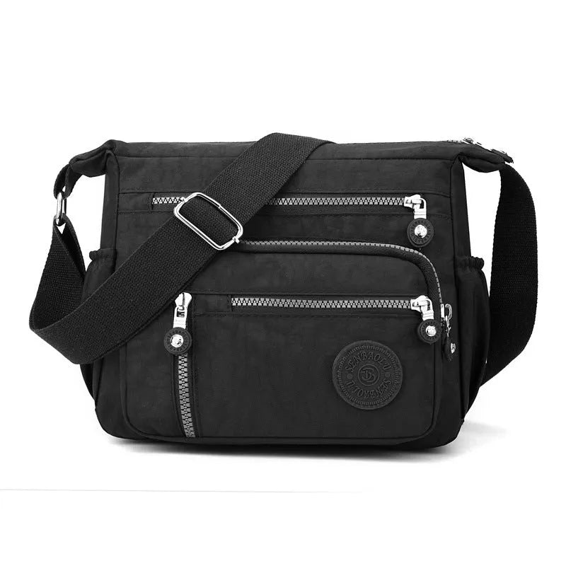Soft grey nylon messenger bag with single shoulder strap showing square vertical shape