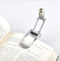 Folding book light in plastic and stainless steel, compact 12cm clip-on reading light for books and e-readers