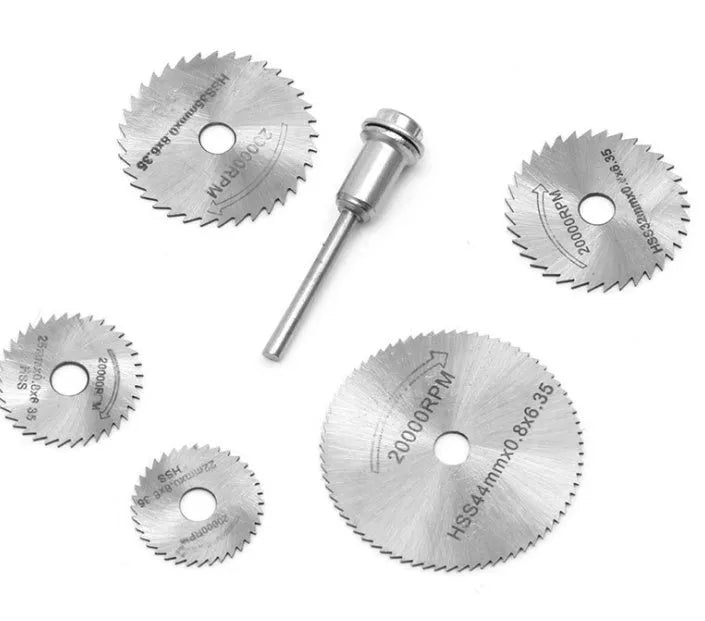 Six circular saw blades with mandrel on dark background showing blade teeth and centre holes