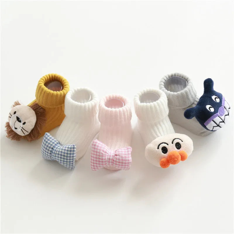 Cotton baby socks in multiple colours and designs including a panda pattern and a blue bow.