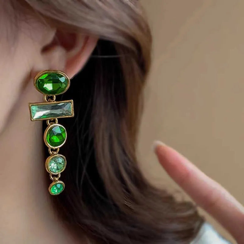 A pair of retro green gradient alloy earrings with geometric Chinese-style design, inlaid zircon stones, and decorative tassels.