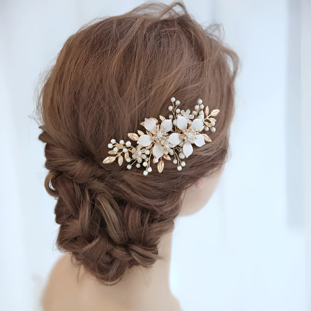 Gold bridal hair comb with pearl and white crystal flower design on head