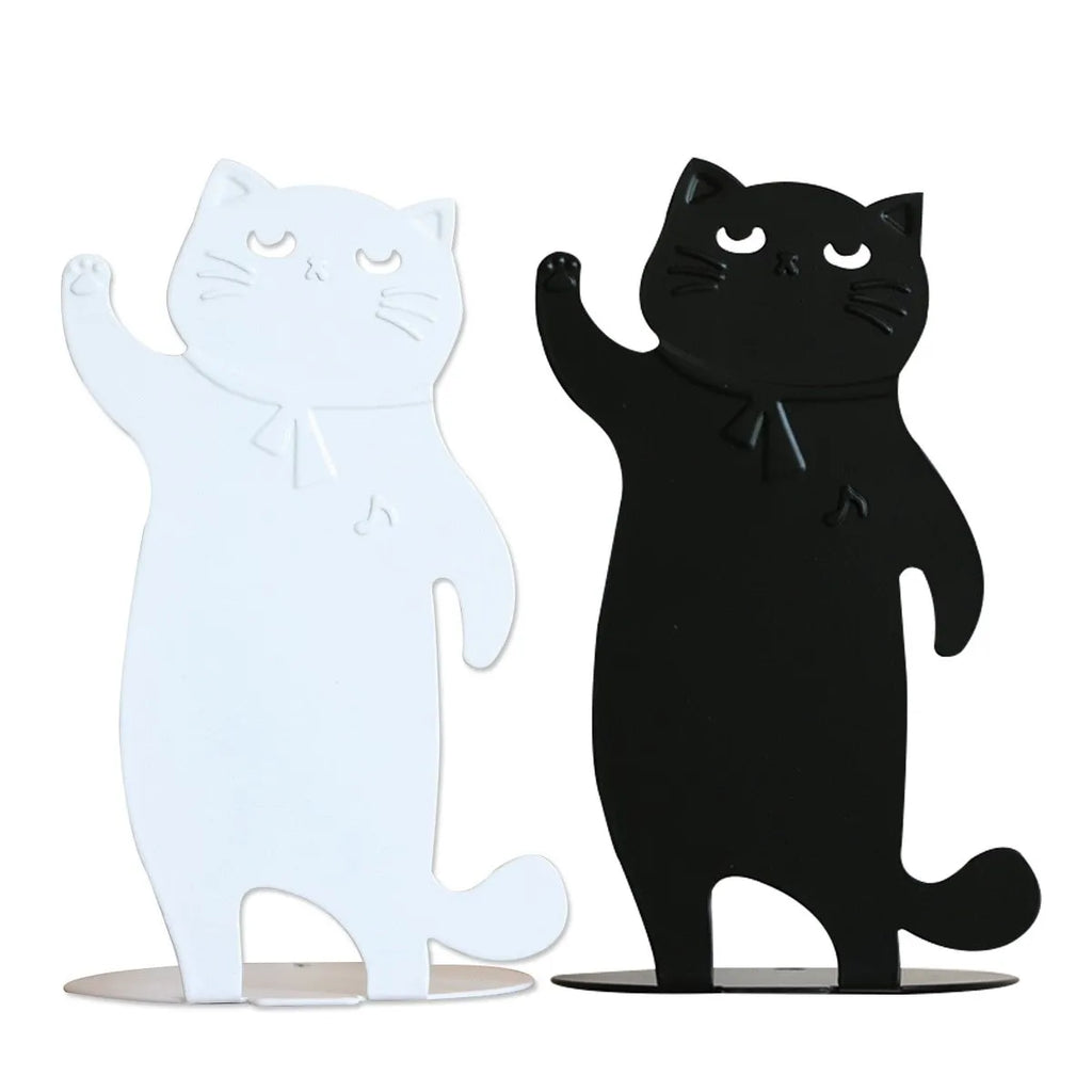 Set of two cartoon cat music themed iron bookends in black and white on a desk holding books upright