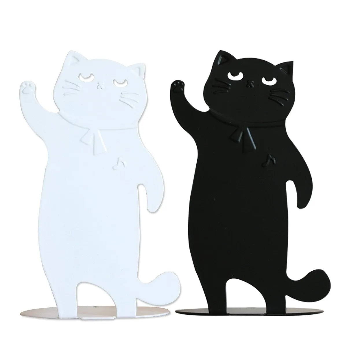 Set of two cartoon cat music themed iron bookends in black and white on a desk holding books upright