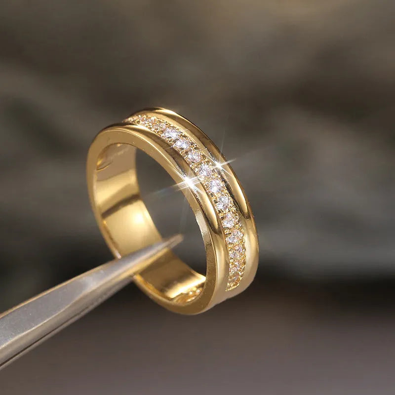Gold plated geometric rhinestone ring with inlaid stone on white background, size options