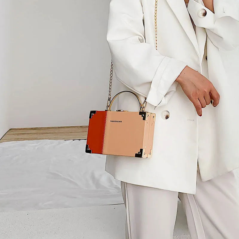 Ladies party clutch bag in orange with box handle and long chain, PU artificial leather, 19x5x12cm