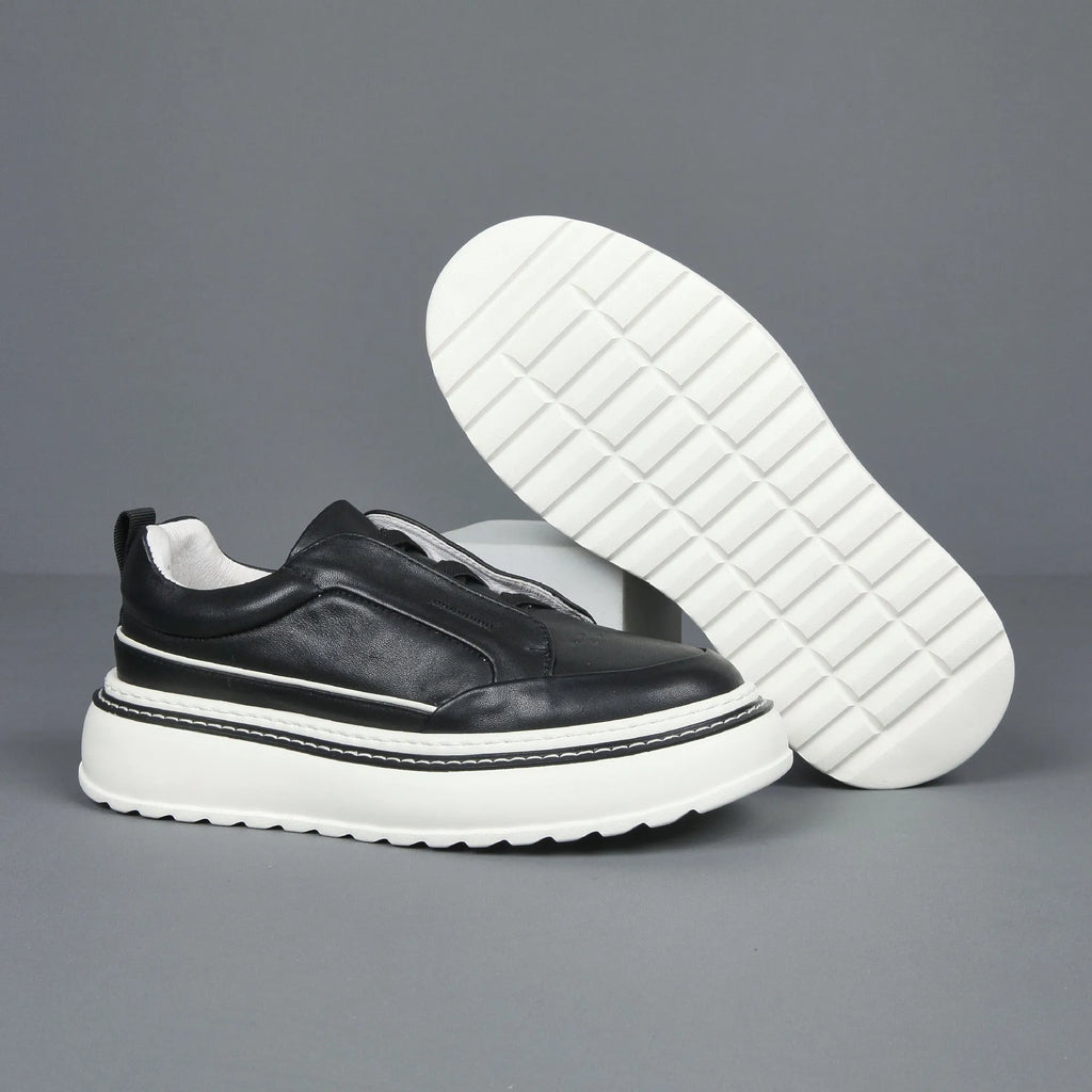 Women's black casual slip-on sneaker with cowhide upper, foam platform sole, round toe, and elastic band
