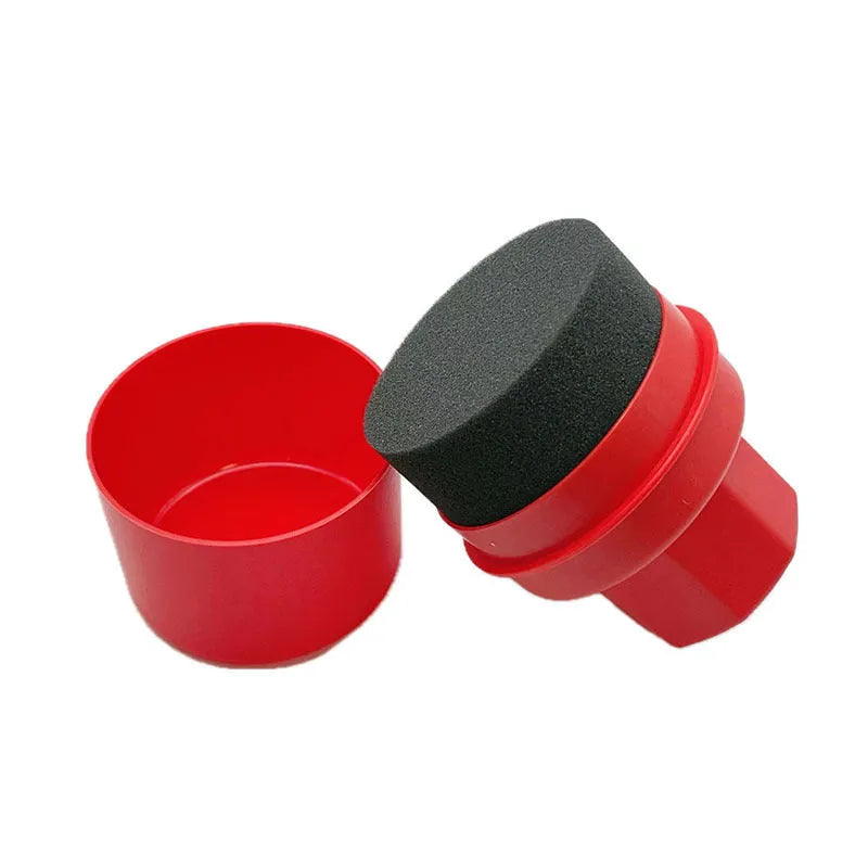 Black and red tyre oil sponge brushes with lids on a white background.