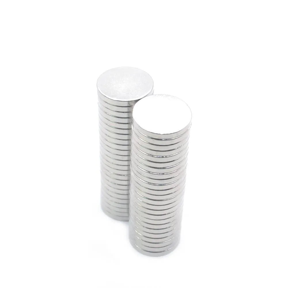 Silver neodymium magnet disc 14x2mm on plain background