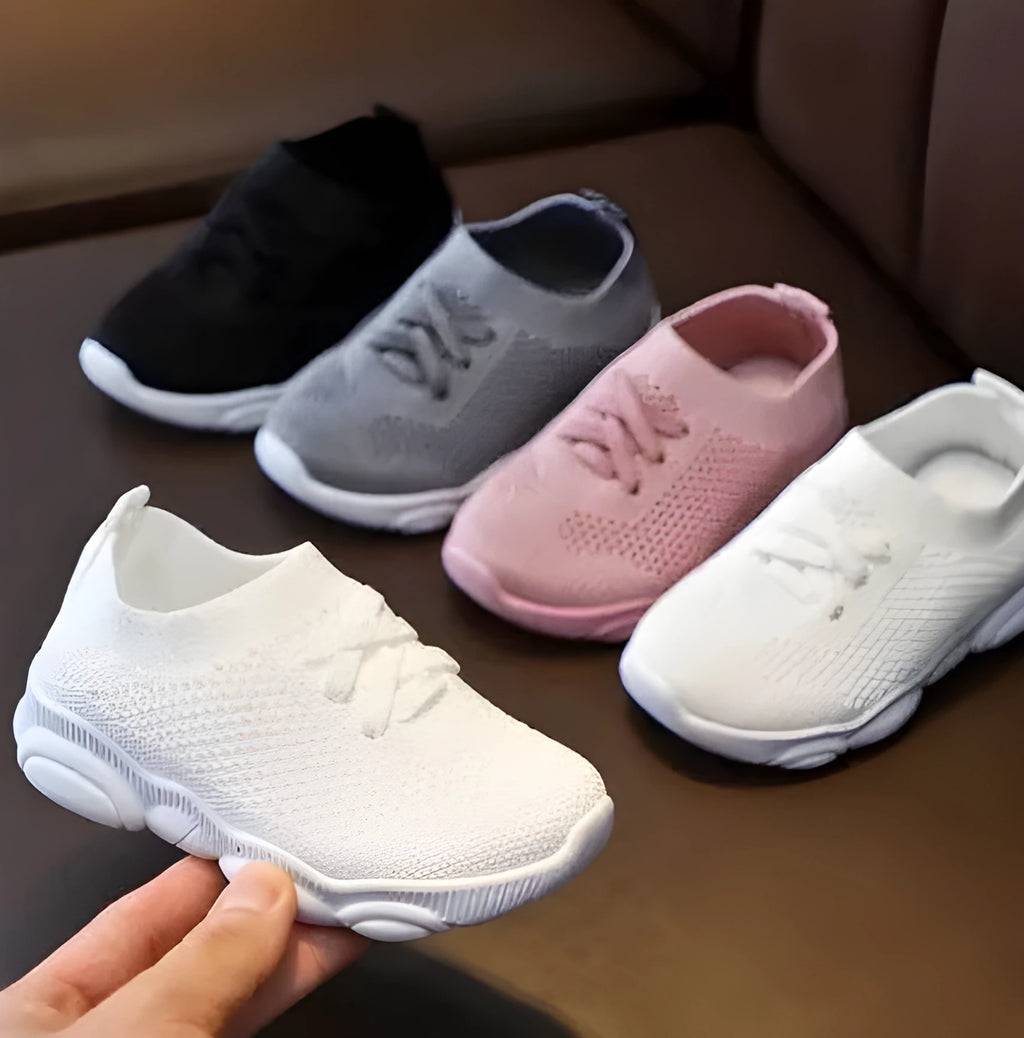 Children's lazy slip-on shoes in white, black, pink, or grey with fabric upper and rubber sole.