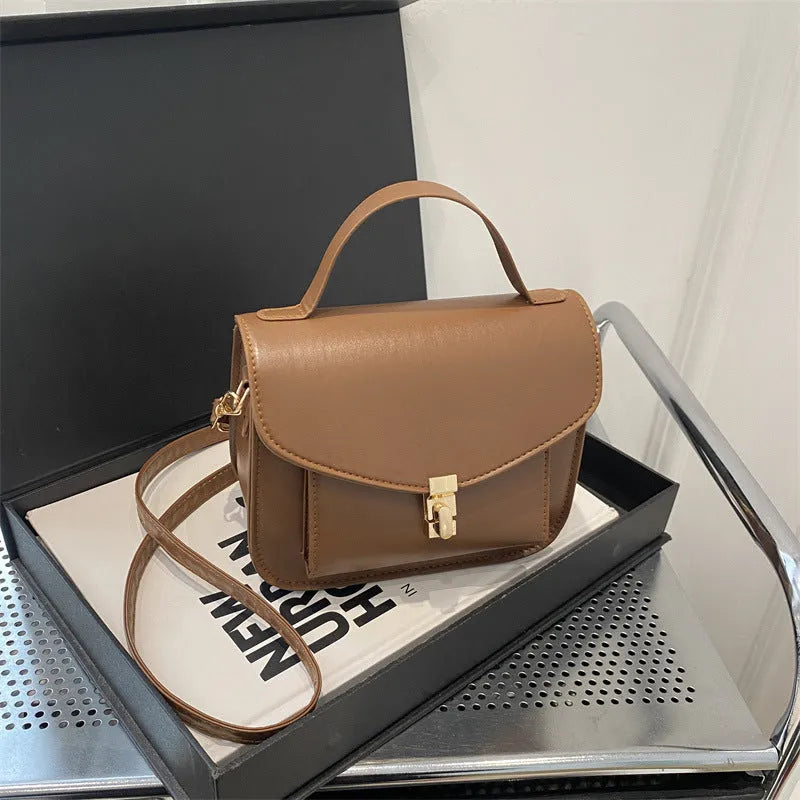 Retro shoulder messenger bag in horizontal square design with crossbody strap and sandwich pocket