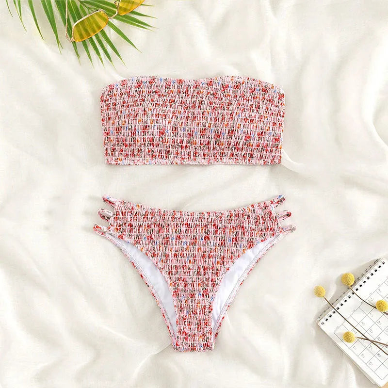 Women's floral strapless swimsuit with split back and high-waist briefs on white background.