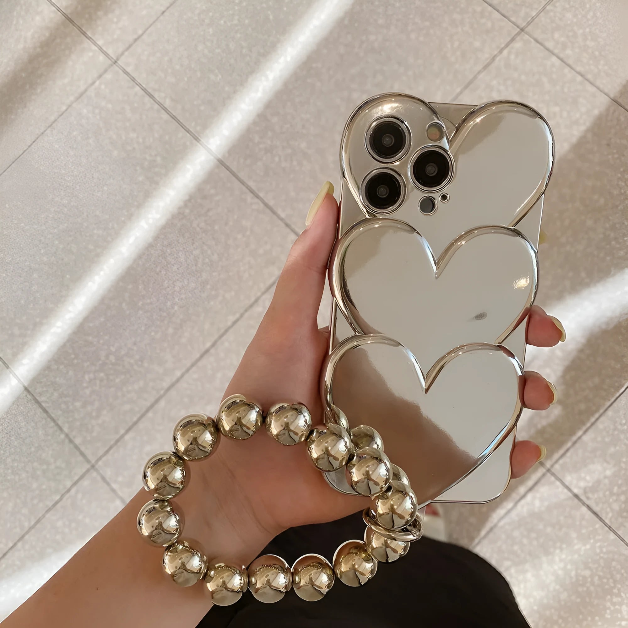 Electroplating love design on a soft TPU iPhone mobile phone case, shown next to a matching bracelet.