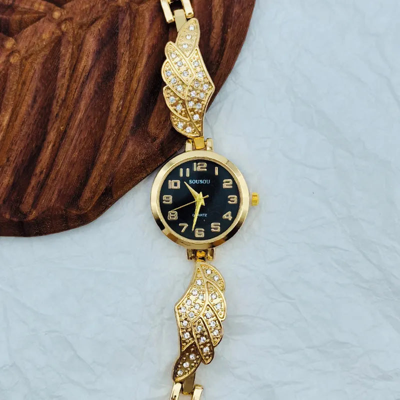 Women's stainless steel watch with round dial showing gold surface and vachette clasp