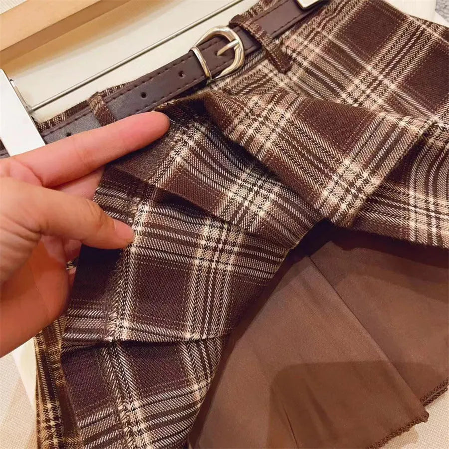 Girls' plaid pleated A-line skirt in a cotton blend fabric, shown on a hanger.