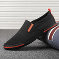 Men's low-top canvas sneakers in grey, black orange, and khaki colours with round toe and vulcanised rubber soles