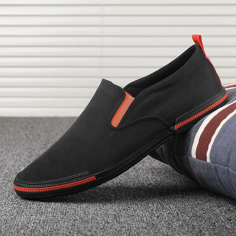 Men's low-top canvas sneakers in grey, black orange, and khaki colours with round toe and vulcanised rubber soles