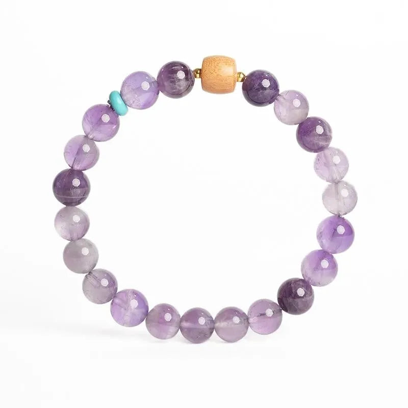 Purple amethyst crystal lucky bracelet for women on a white background.