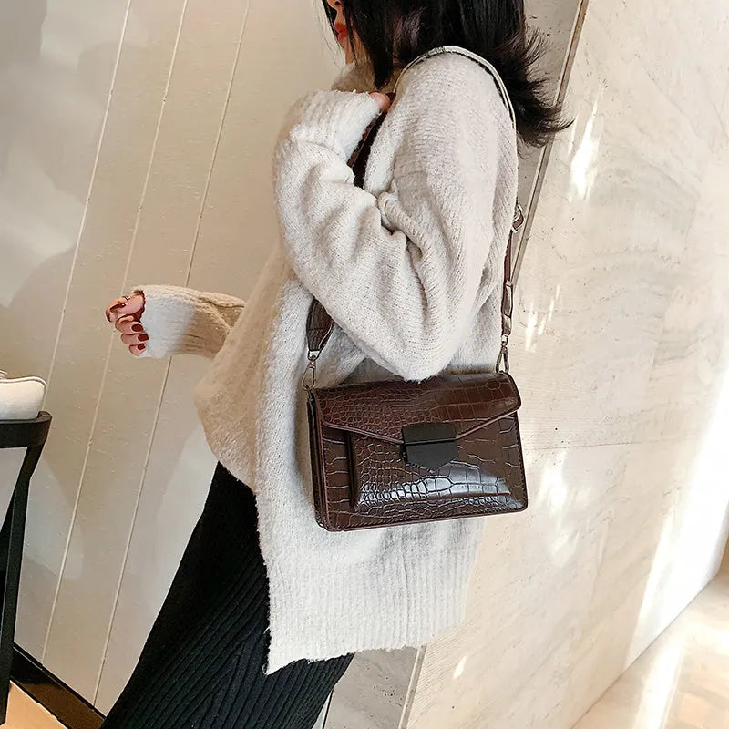 Vintage PU leather crossbody bag in black, shown with dimensions 20cm wide by 14cm high