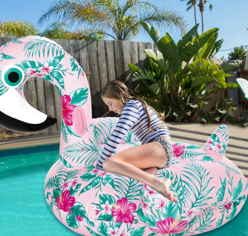 Inflatable pink flamingo swimming float and swim ring for adult and child pool use