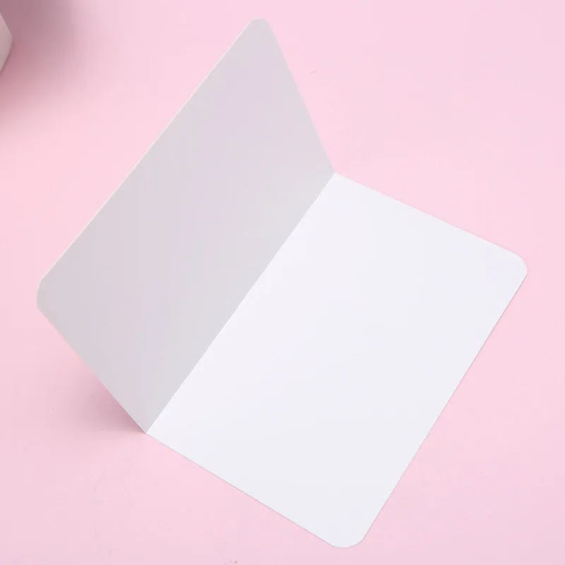 Pack of 100 folded kraft cards in 10x15 cm size, showing black, cowhide, and white colour options.