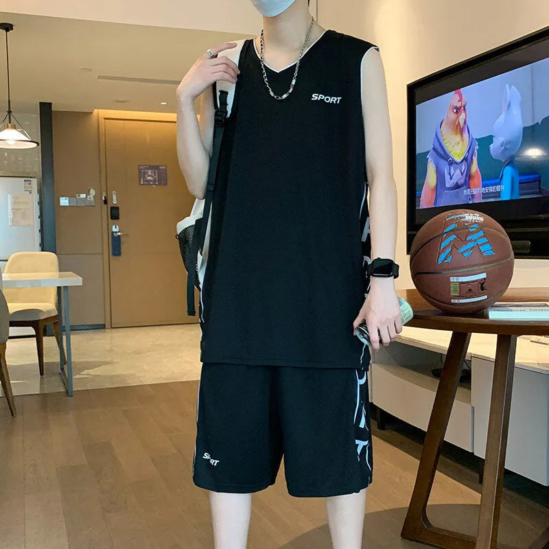 Man wearing a grey sleeveless polyester vest and matching shorts basketball sports set.