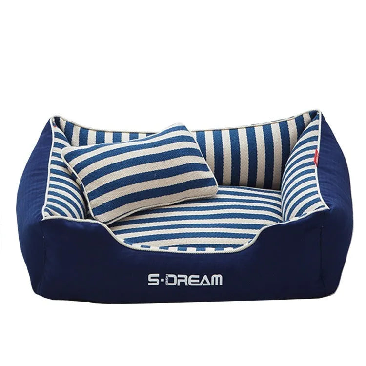 Navy striped washable dog kennel mat with removable cover and a red mini pillow.