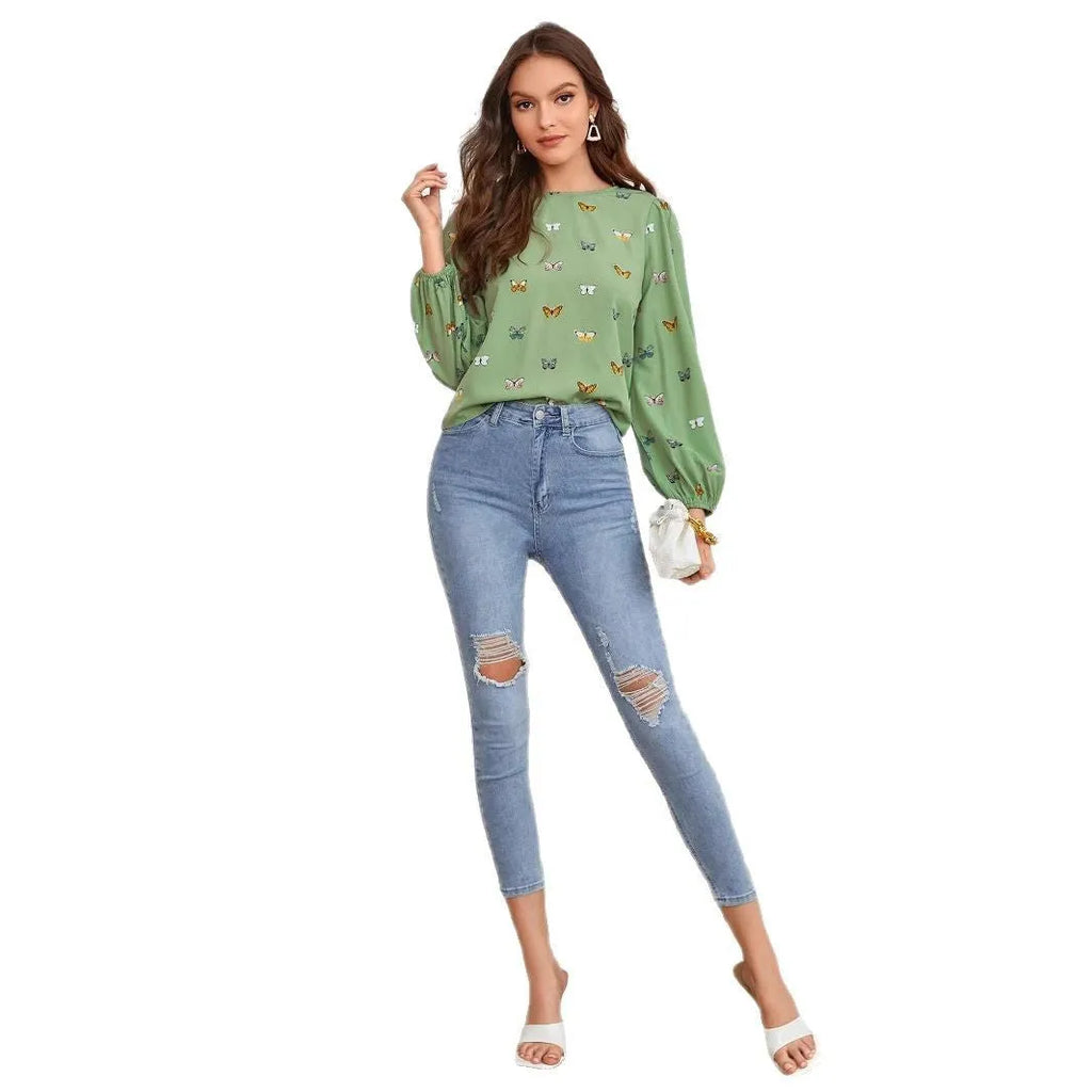 Women's green long-sleeved shirt with butterfly print pattern and loose fit.