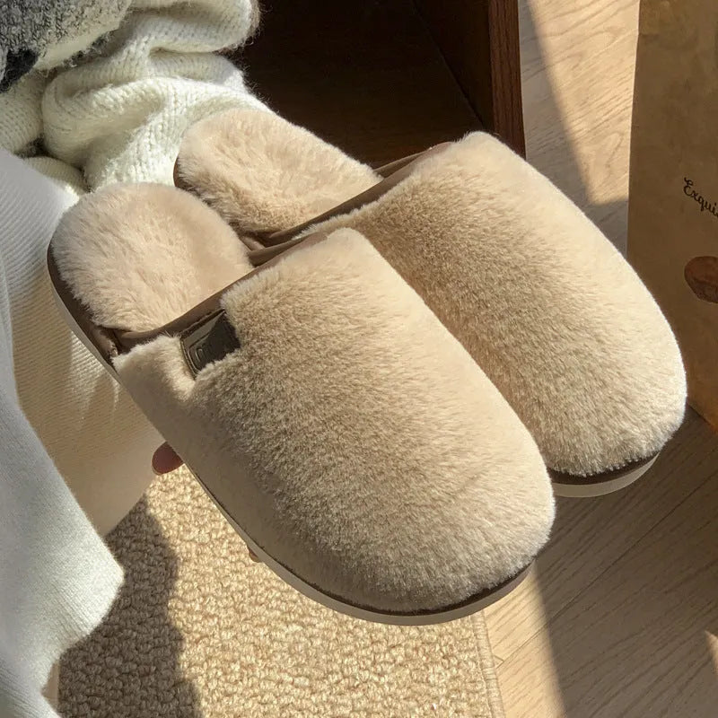 Pair of solid-colour plush winter slippers with a PVC upper and non-slip sole.