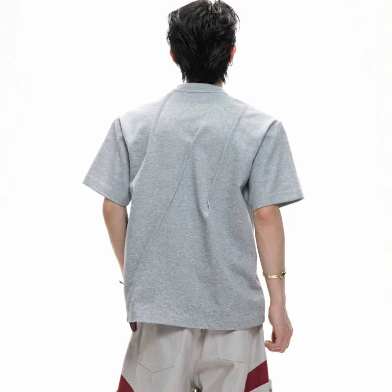 Men's black cotton t-shirt with three-dimensional pleats and a round neck, laid flat.