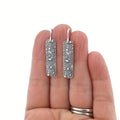 Silver geometric long earrings with a carved vine pattern in a retro style