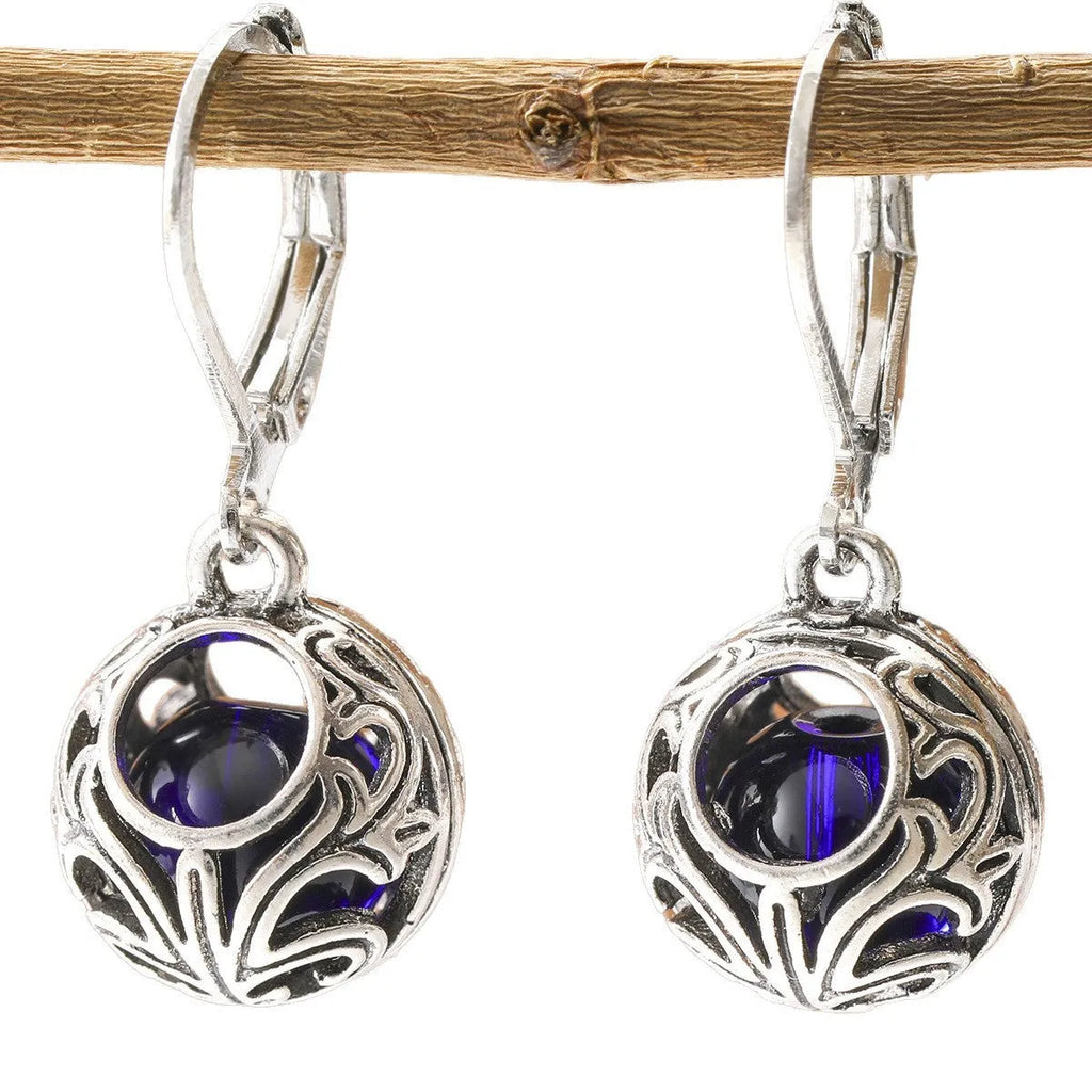 Silver geometric earrings with blue gemstone pendants and hollow engraving details