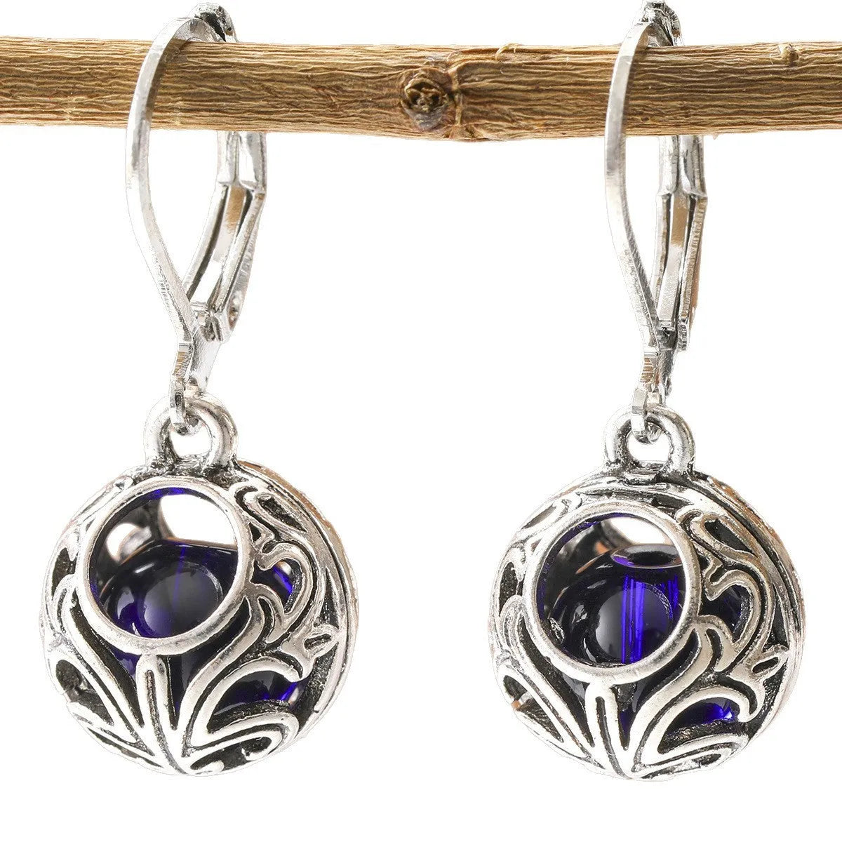 Silver geometric earrings with blue gemstone pendants and hollow engraving details