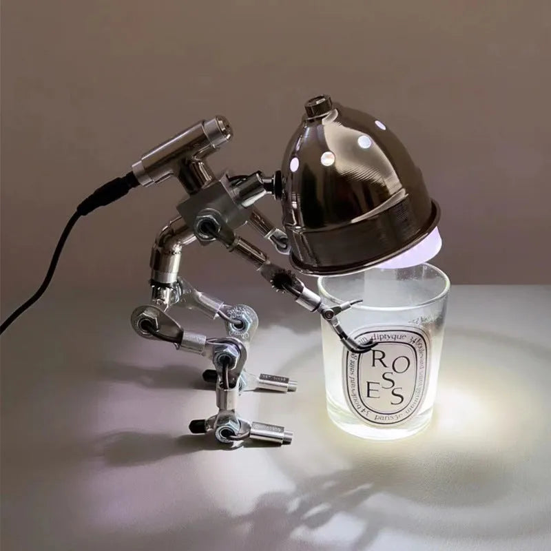 Creative robot-shaped desk lamp in silver or copper, available in 22cm and 29cm sizes.