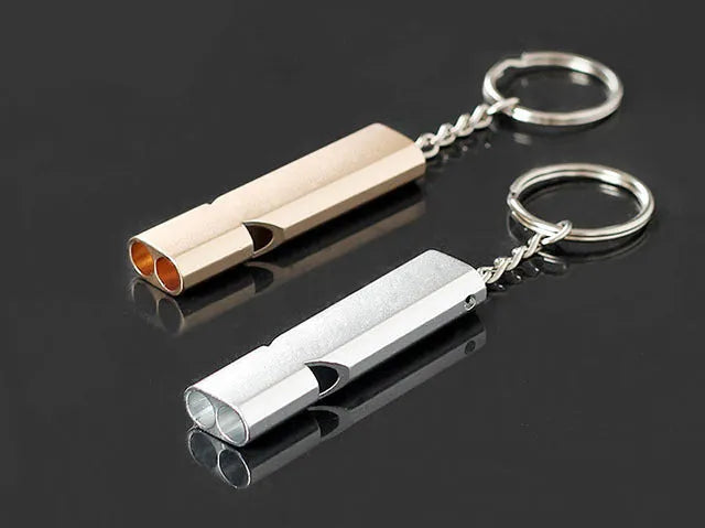 Silver and gold aluminium alloy outdoor survival whistle with double hole design.