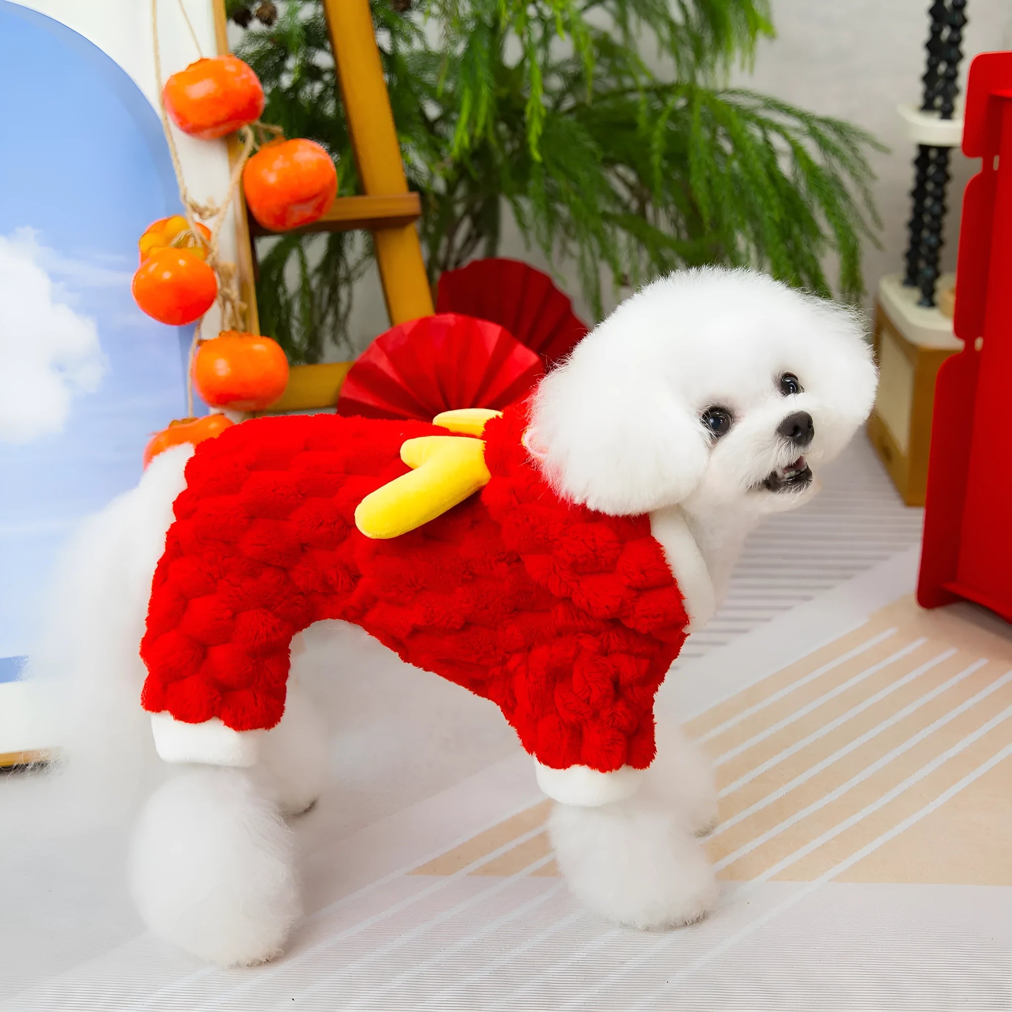 Red velvet pet jacket with cartoon dragon design for dogs and cats on a hanger
