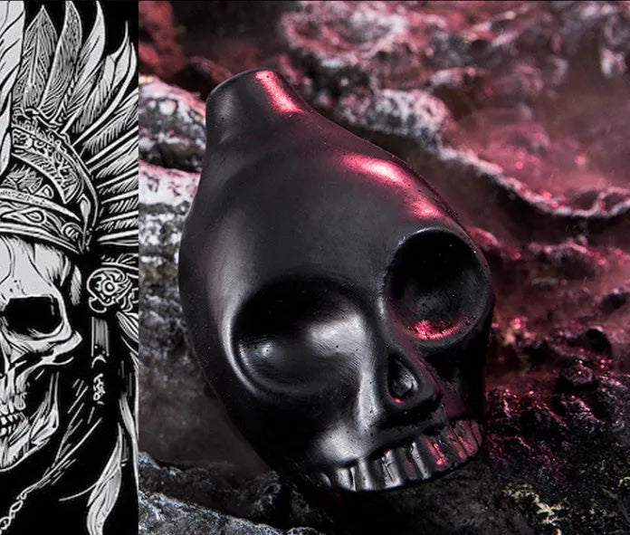 Skull whistle decompression toy in dolomite ceramic, shown in matte black and red and black colour options