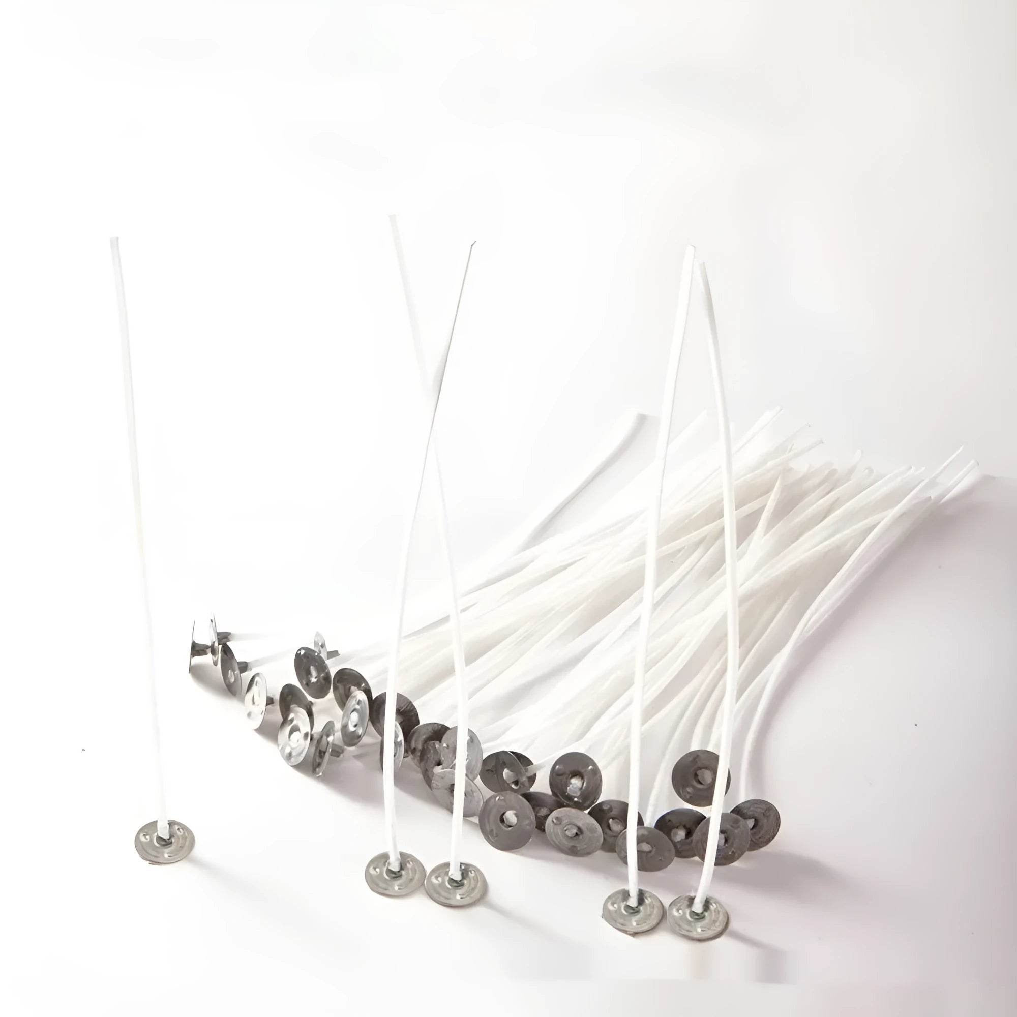 White cotton candle wicks for DIY candle making in three lengths: 2.6cm, 6cm, and 8cm