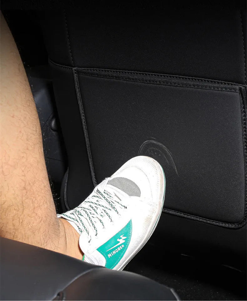 Two black leather rear seat anti kick pads measuring 68cm by 42cm for car seat back protection