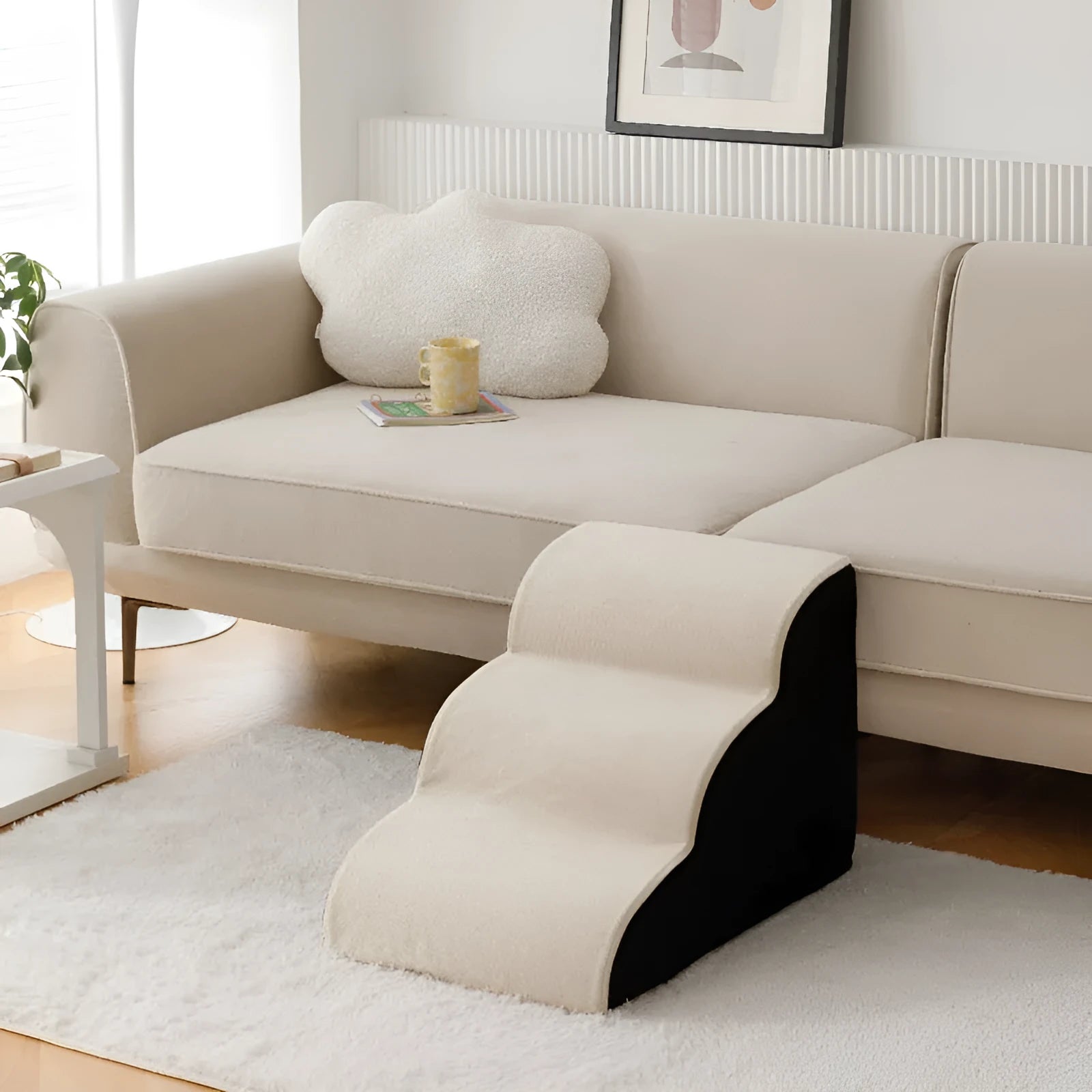 Brown wooden pet stairs with removable fabric steps helping a small dog reach a sofa