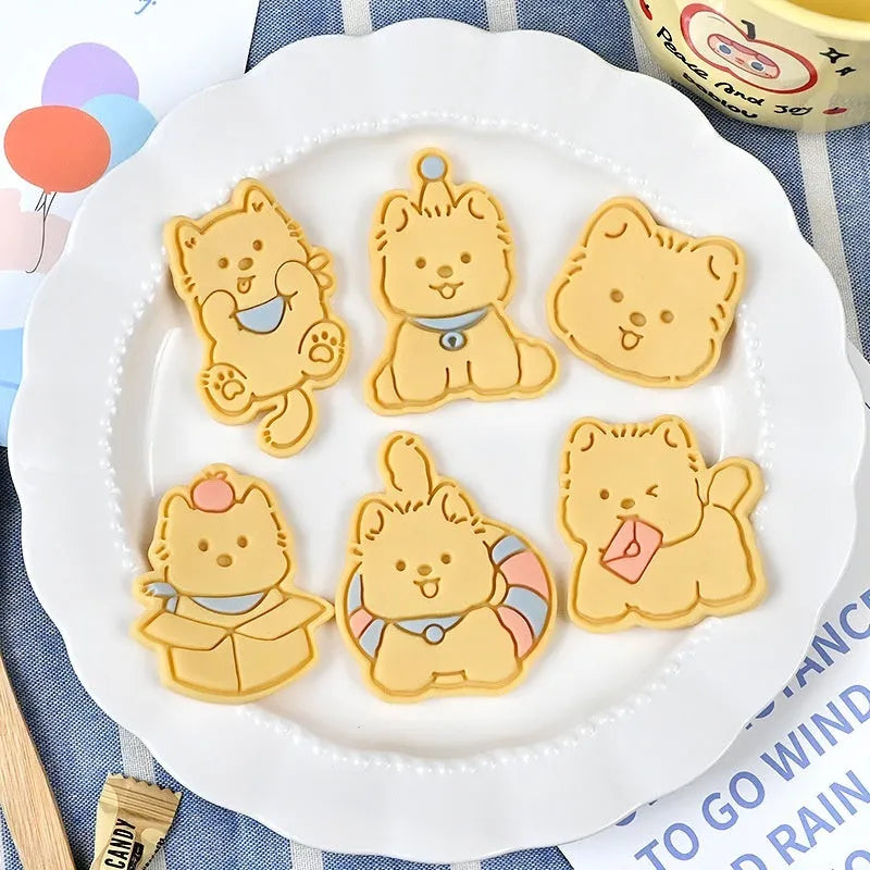 Plastic biscuit mould with puppy head designs including birthday hats and swimming rings